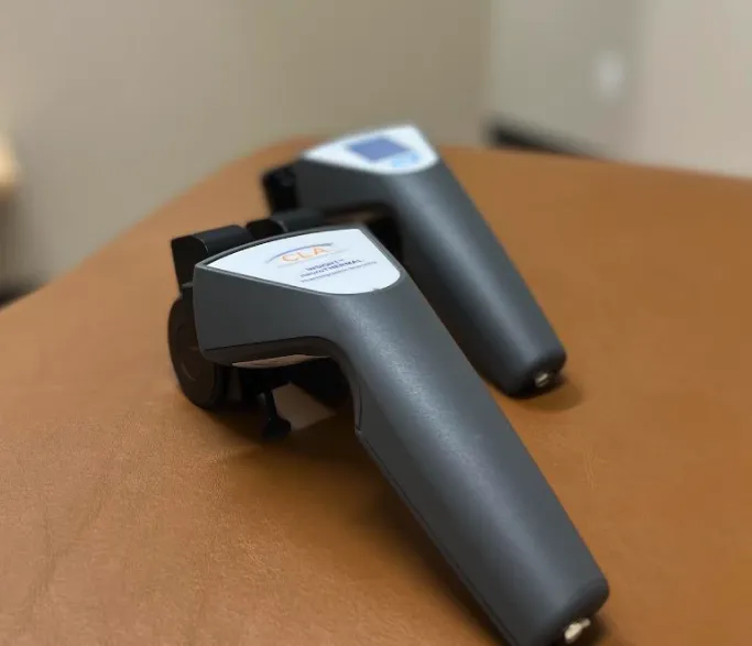 Chiropractic assessment tools on a treatment table, showcasing CLA technology for evaluating stress and nerve interference during consultations at Desert Pine Chiropractic.