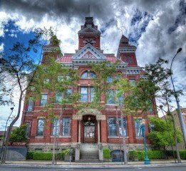 Whatcom Museum historic building in Bellingham, featuring red brick architecture and decorative towers, surrounded by trees.